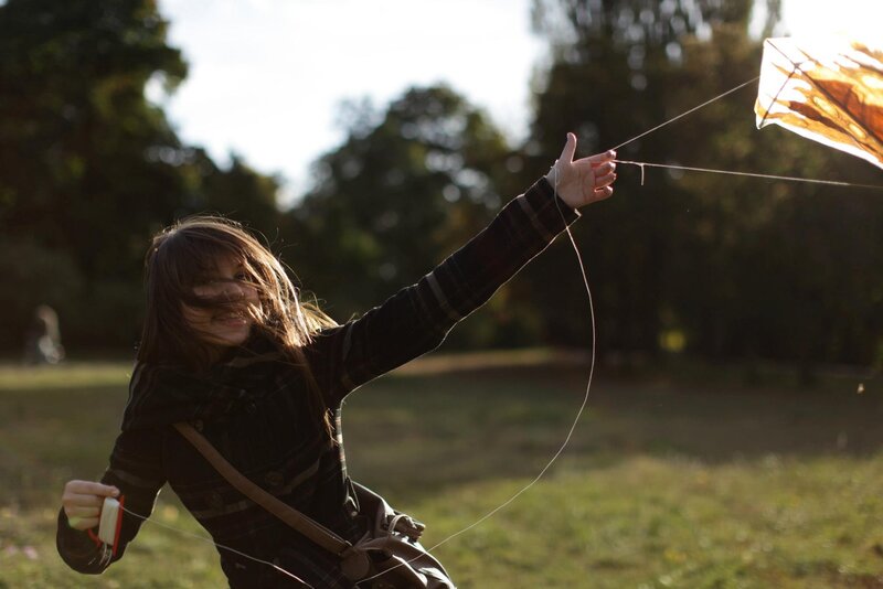 Girl flying a kite in park