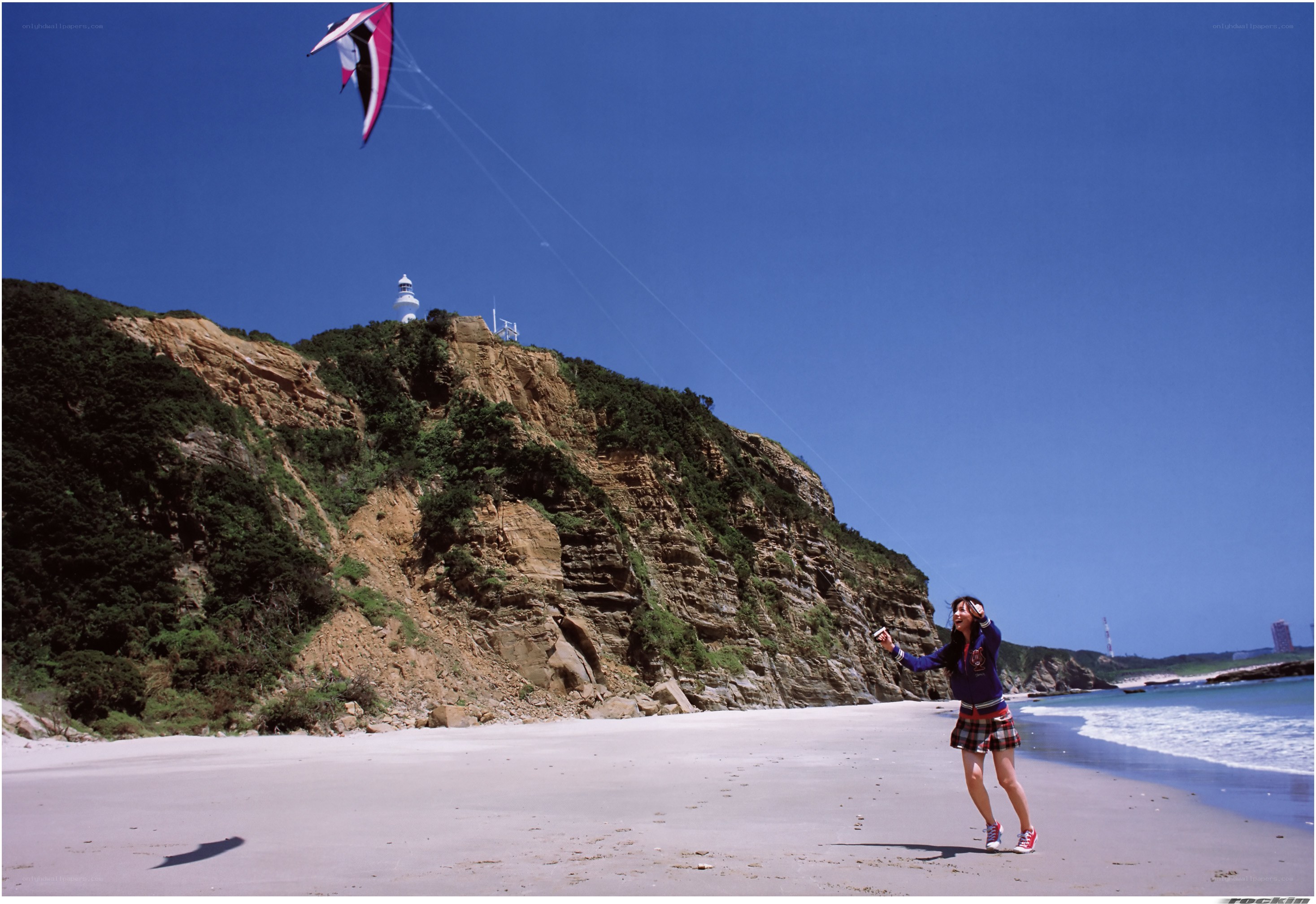 Girl flying kite on beach