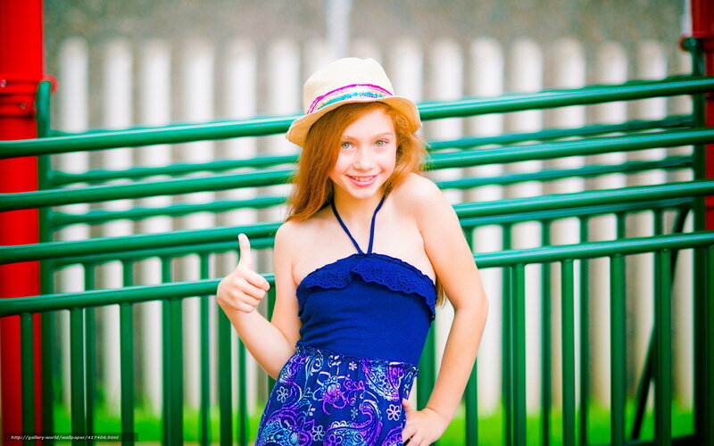girl giving thumbs up at playground