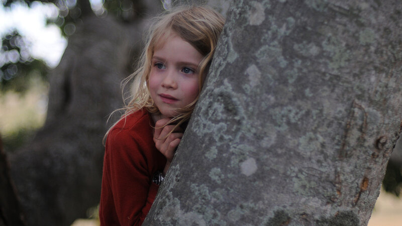 Girl Hiding Behind Tree