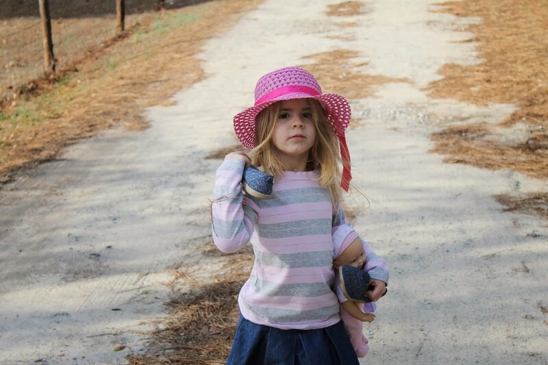 Girl Holding a Doll — Pink