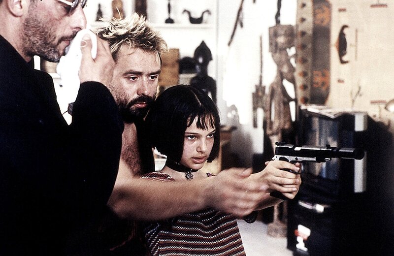 Girl holding a gun in a room