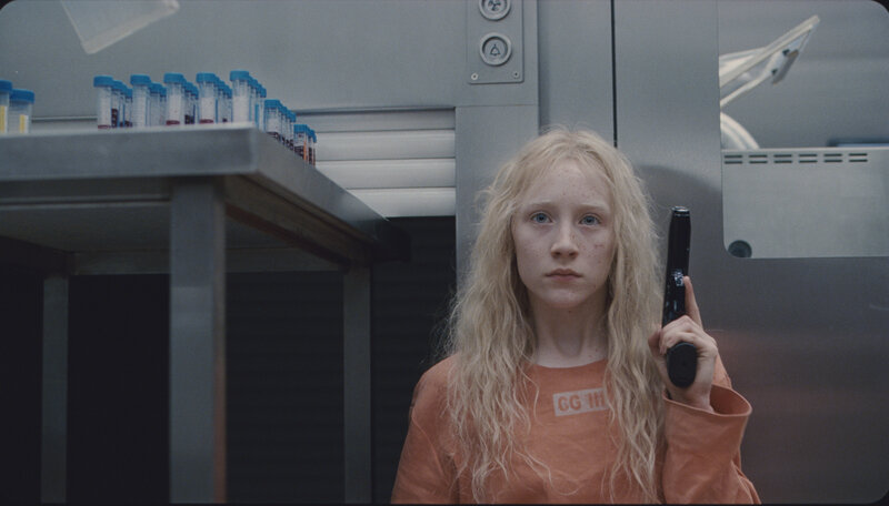 Girl holding a gun in lab
