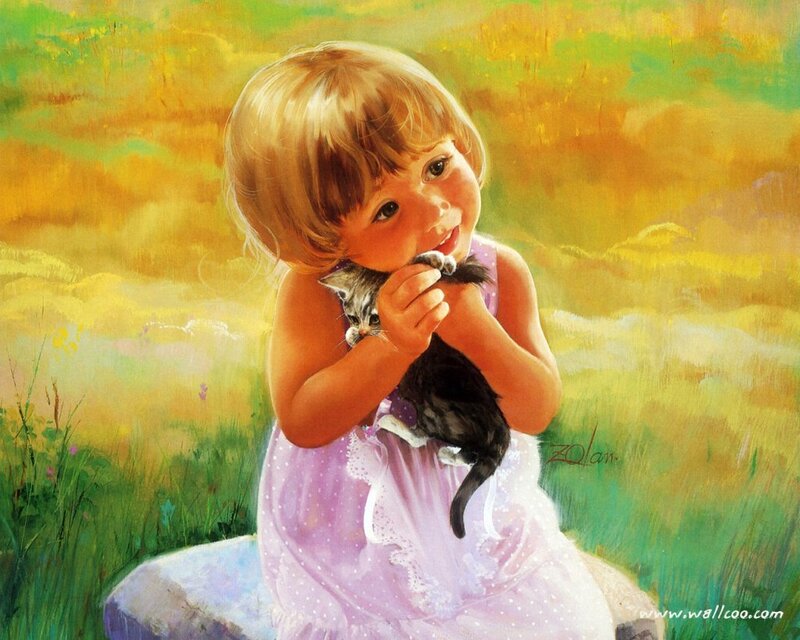 Girl holding a kitten in a field