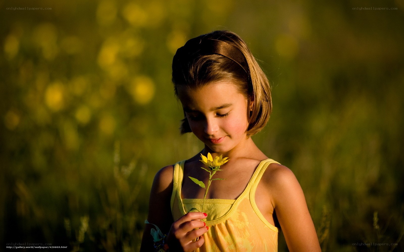 Girl holding a yellow flower