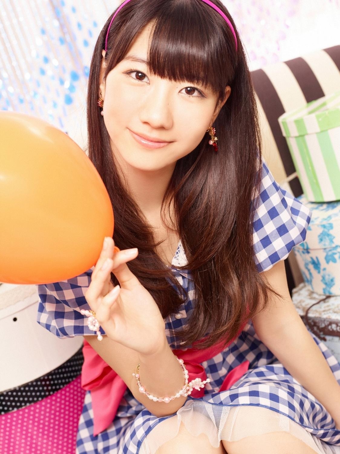 Girl holding an orange balloon