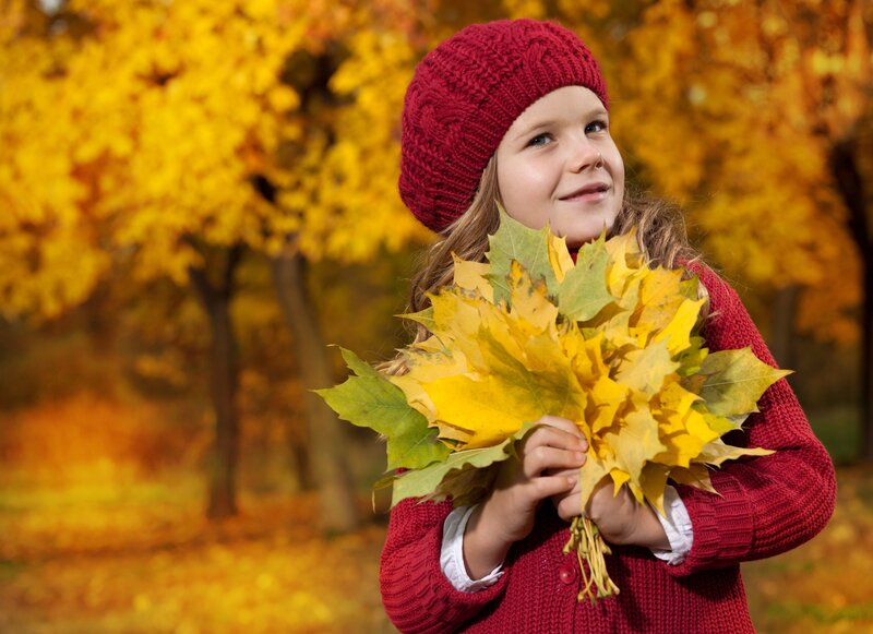 Girl Holding Autumn Leaves — Yellow
