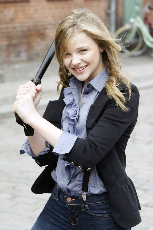 girl holding bat outdoors