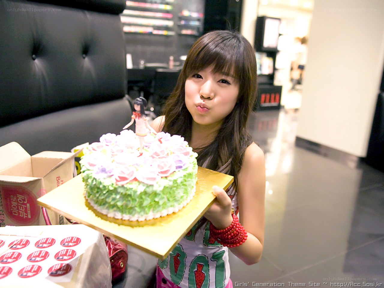girl holding birthday cake