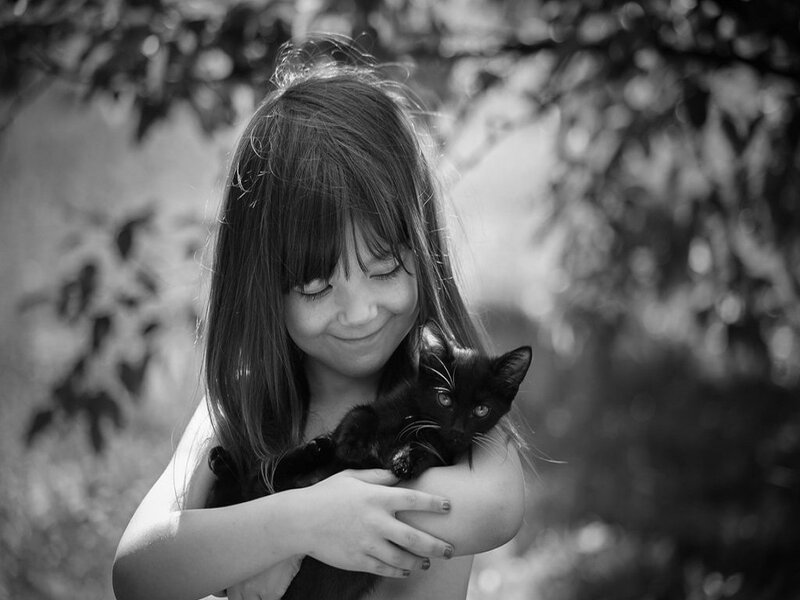 Girl Holding Black Kitten