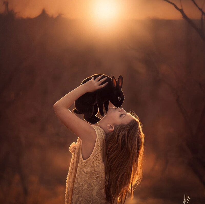 Girl Holding Black Rabbit