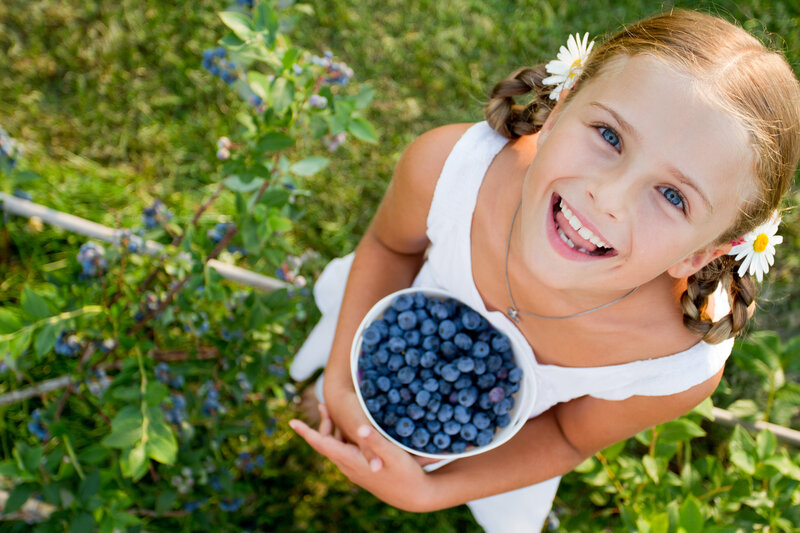 Girl Holding Blueberries