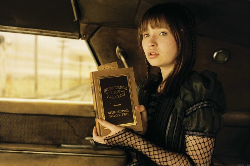 girl holding book in car