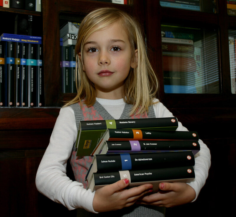 Girl holding books in library