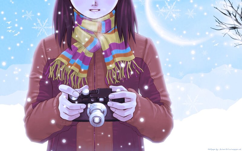 girl holding camera in snow