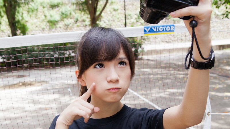 Girl holding camera on court