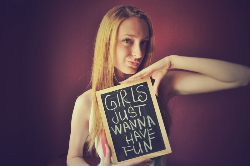 Girl holding chalkboard sign