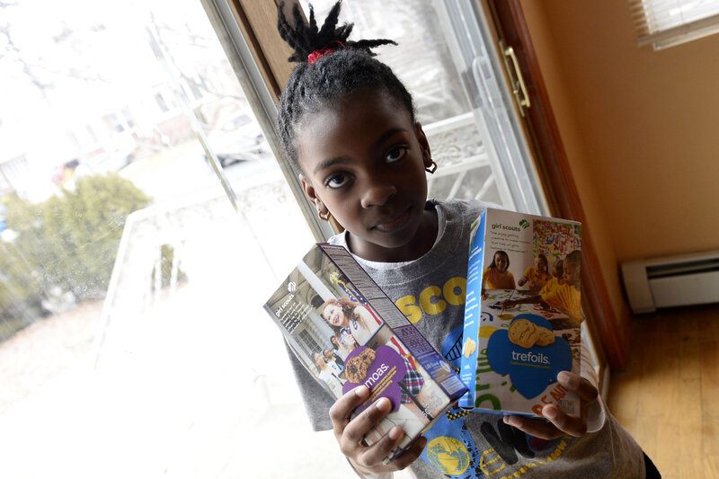 Girl Holding Cookie Boxes