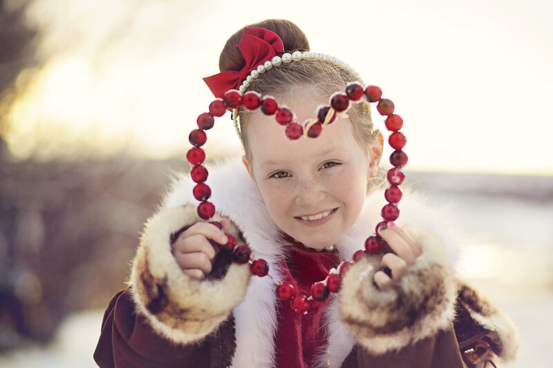 Girl Holding Cranberry Necklace
