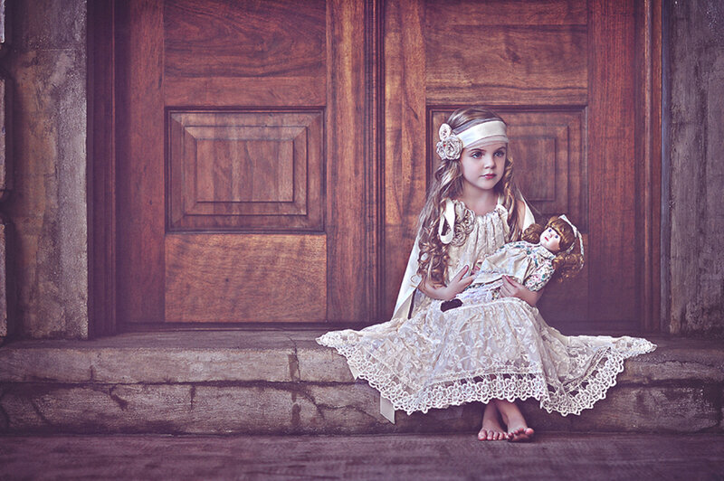 Girl Holding Doll — Brown, Dramatic