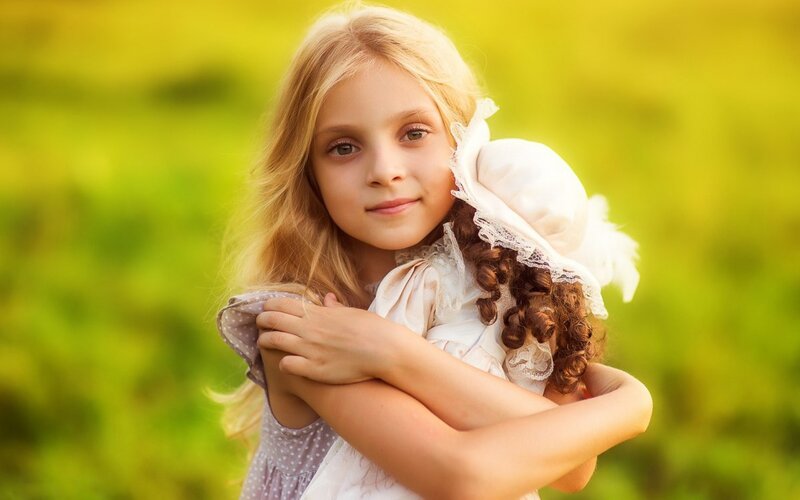 Girl Holding Doll — Green, Serene