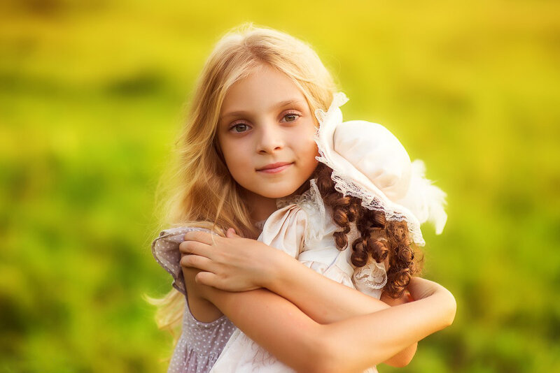 Girl Holding Doll — Green