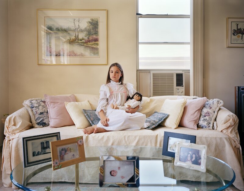 Girl Holding Doll on Couch
