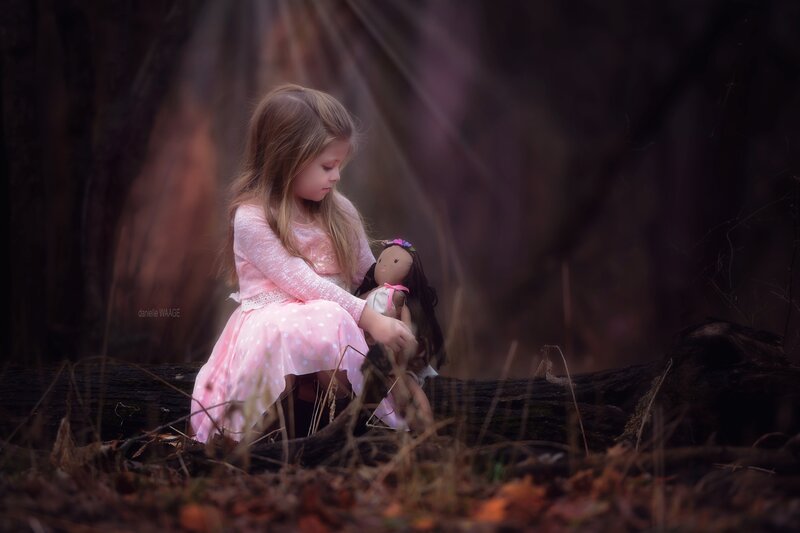 Girl Holding Doll — Pink, Serene