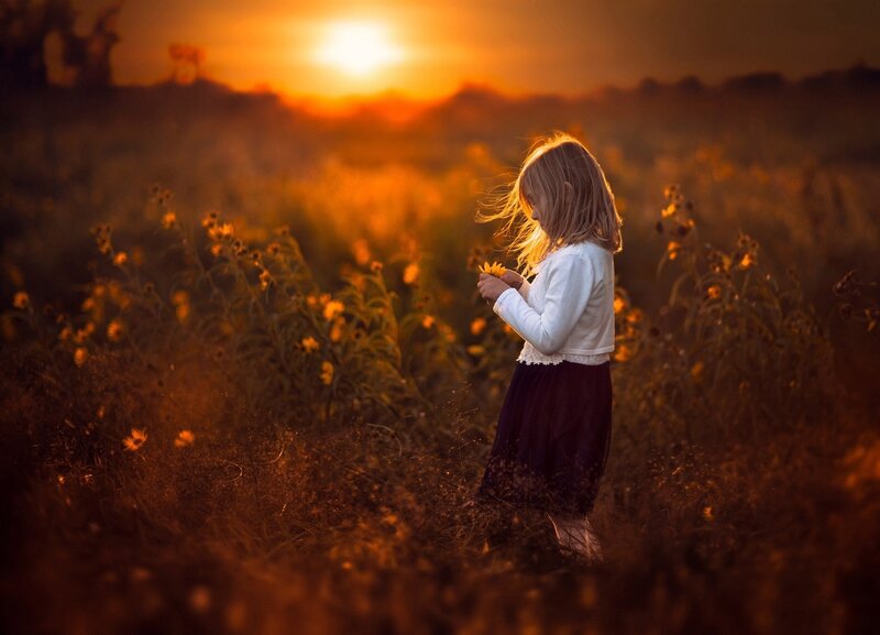 Girl Holding Flower — Orange, Serene, Sunset