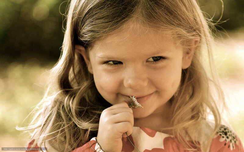 girl holding flower outdoors