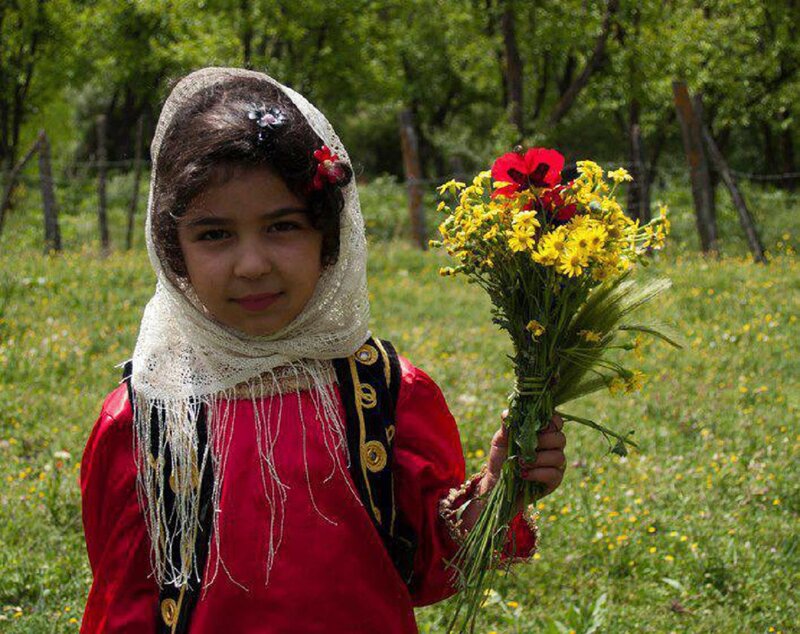Girl Holding Flowers — Red, Serene, Spring