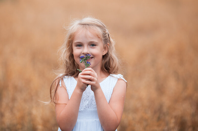 Girl Holding Flowers — White, Serene, Afternoon, Photograph