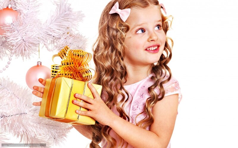 girl holding gift near tree