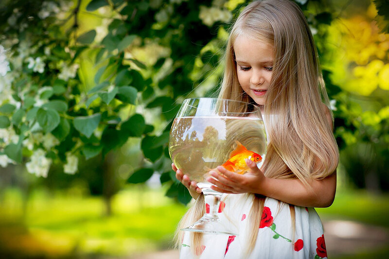 Girl Holding Goldfish Bowl