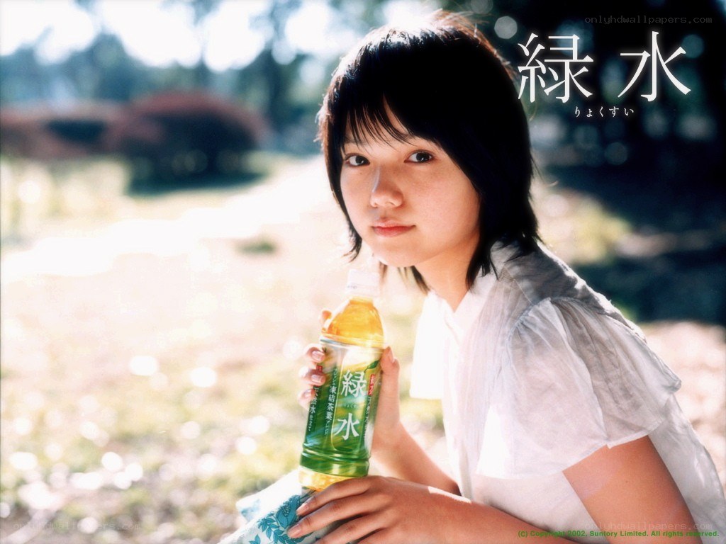 girl holding green tea bottle