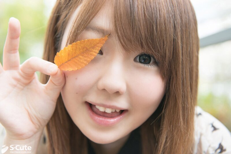 girl holding leaf over eye