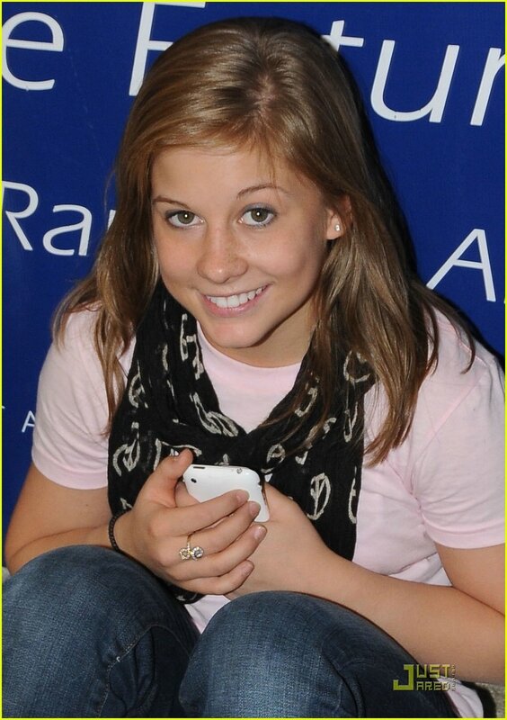 girl holding phone at event