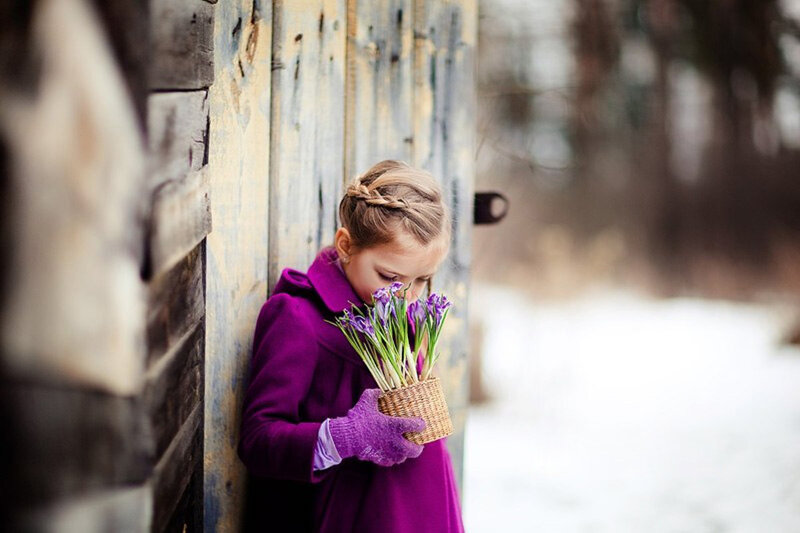 Girl Holding Purple Flowers