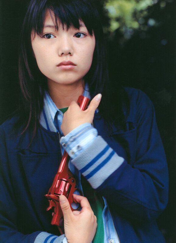 Girl holding red toy gun