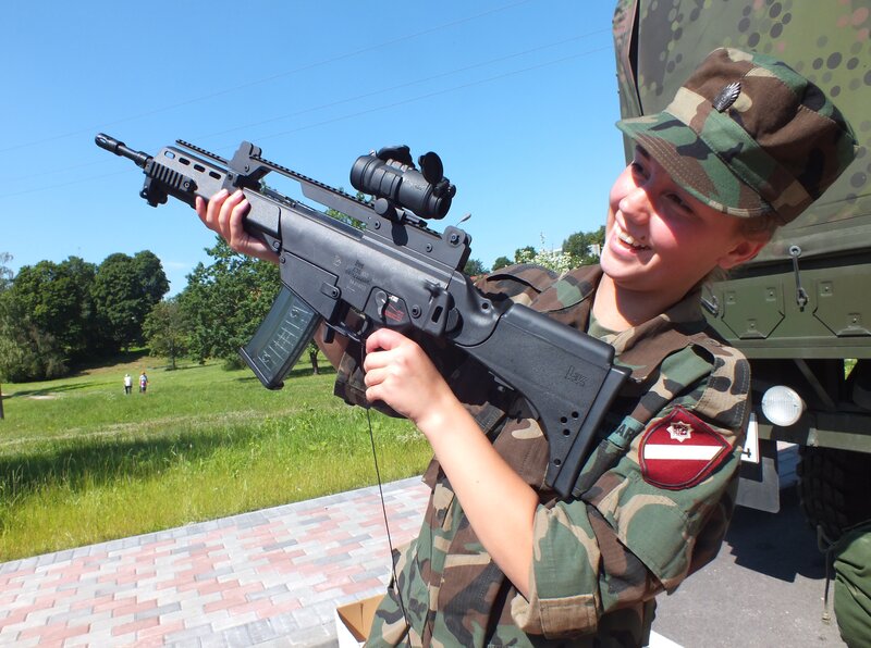 Girl Holding Rifle — Green