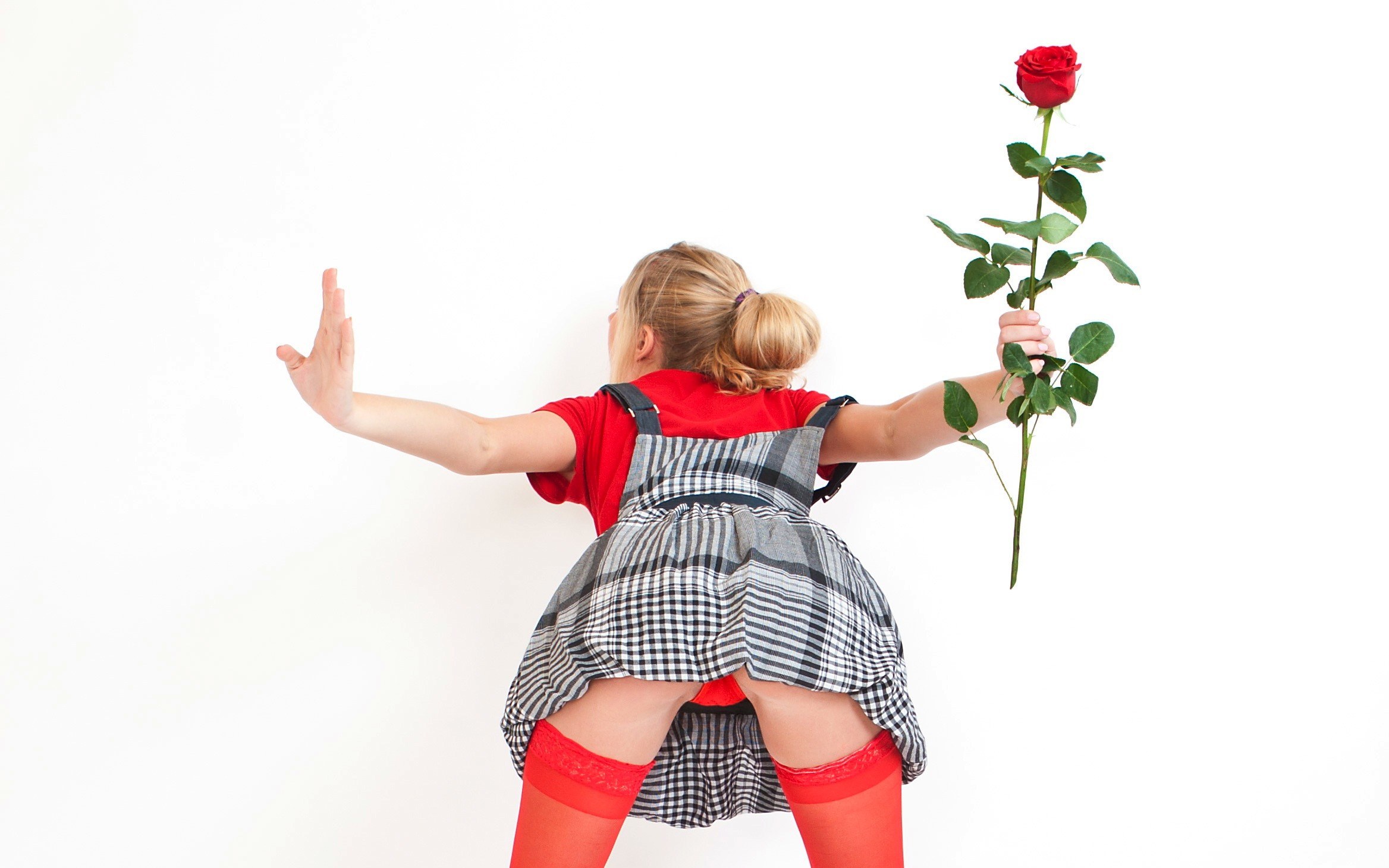 girl holding rose from behind