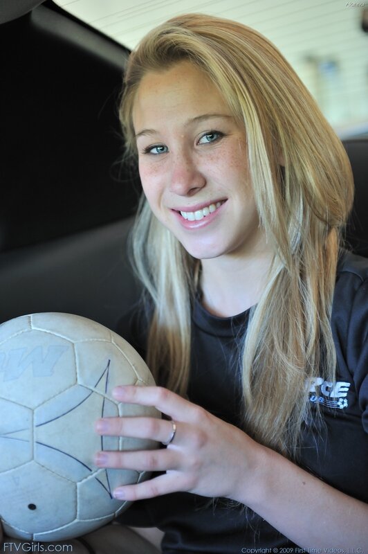 girl holding soccer ball