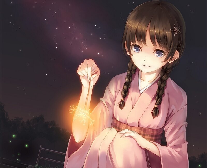 girl holding sparkler at night