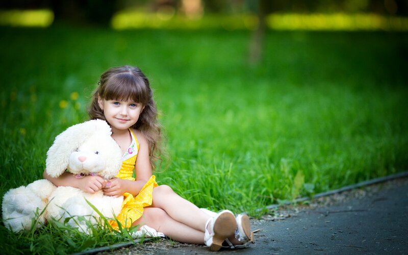 Girl Holding Stuffed Animal — Green
