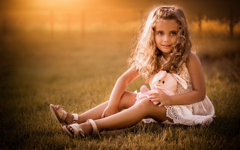 Girl Holding Stuffed Bunny — Golden