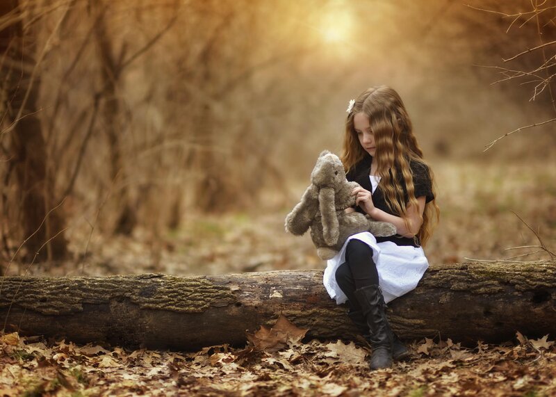 Girl Holding Stuffed Rabbit — Brown