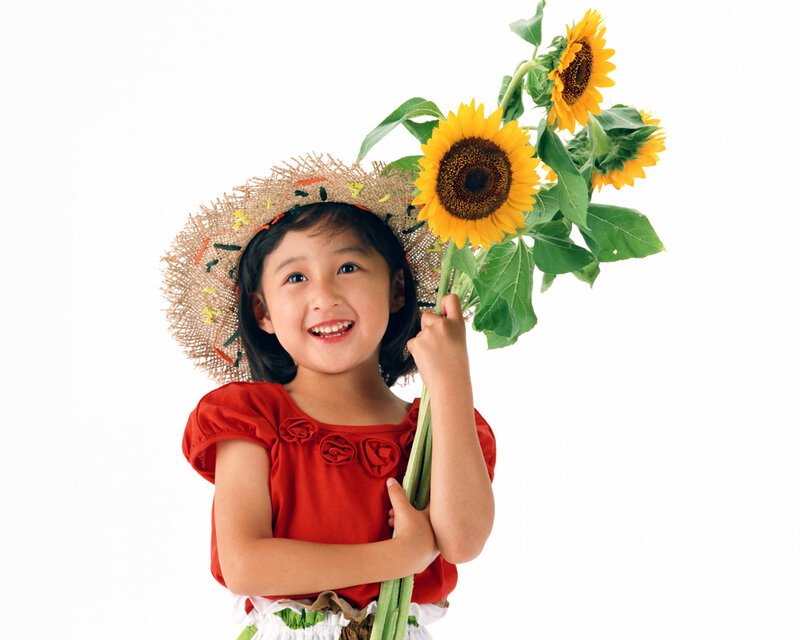 girl holding sunflowers