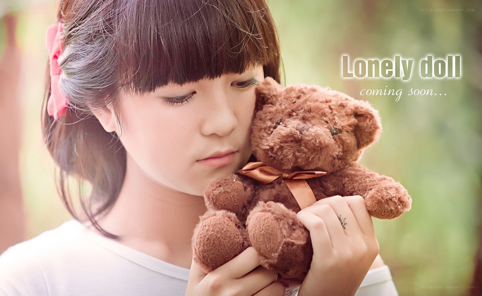 girl holding teddy bear