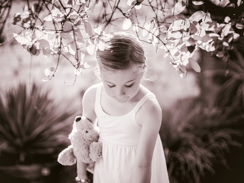 Girl Holding Teddy Bear — Black, Serene