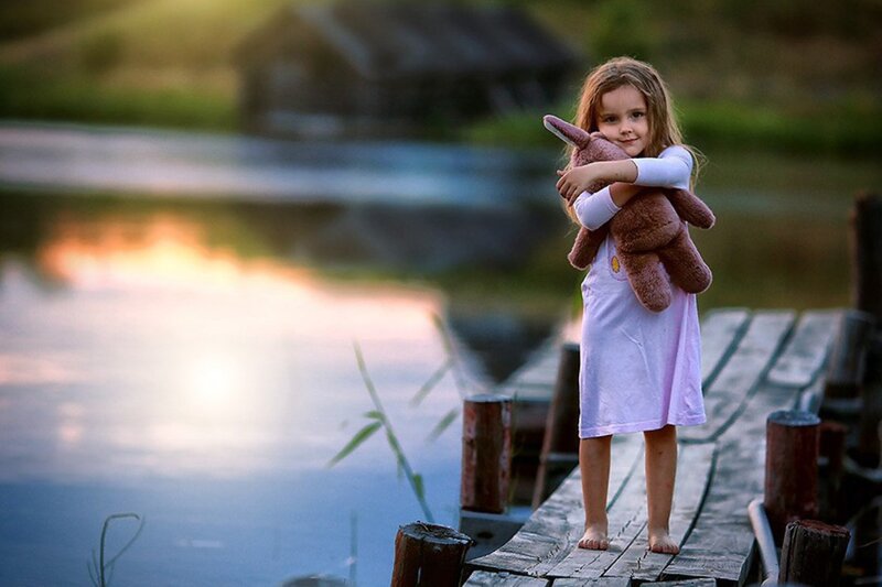Girl Holding Teddy Bear — Blue, Serene, Sunset